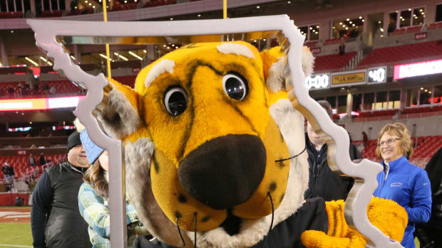 Missouri Tigers mascot poses with the Battle Line trophy after the game against the Arkansas Razorbacks at Donald W. Reynolds Razorback Stadium. Missouri won 48-14.